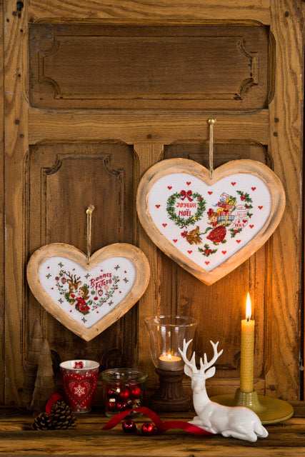 Lot de 2 cadres cœur de Noël en bois naturel avec accroche ficelle. Grand modèle 21×15 cm, petit modèle 10×17 cm. Grille disponible dans Création Point de Croix N° 109 (non inclus).