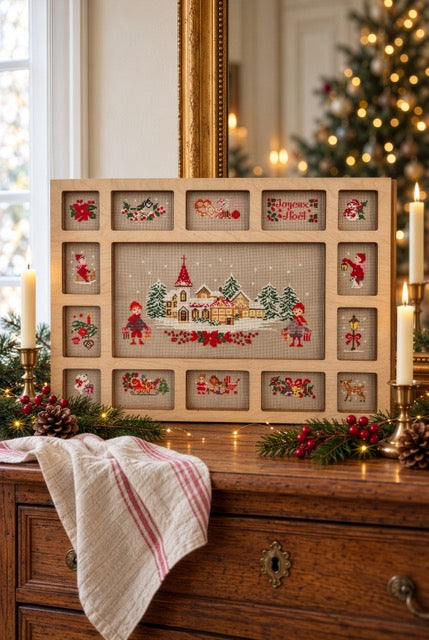 Composez votre tableau de Noël avec ce cadre casier en bois à broder de 42 × 30 cm. Grille disponible dans Création Point de Croix n°121.