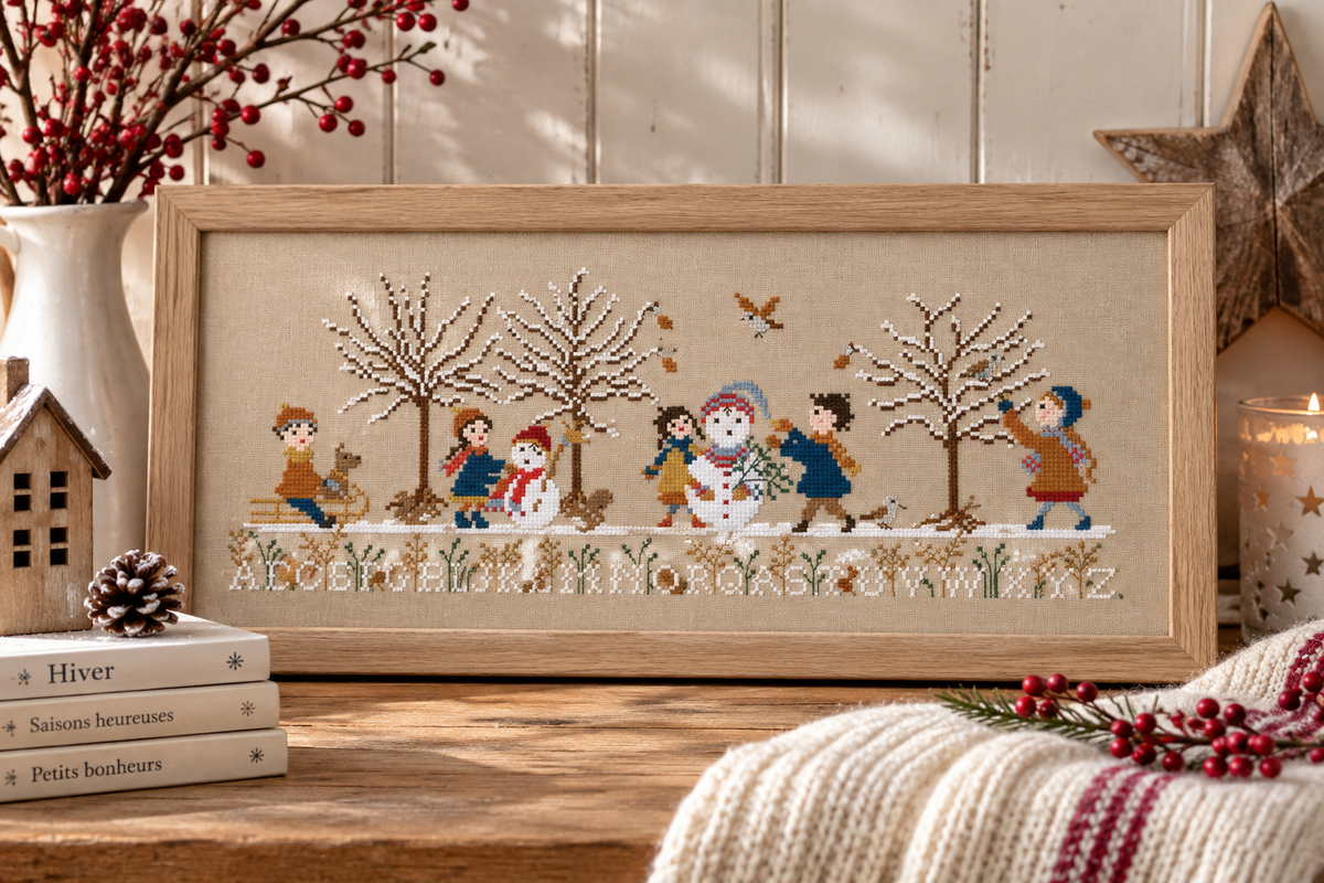 Brodez Les joies de l’hiver de Perrette Samouïloff, une scène enneigée avec enfants, luge et bonshommes de neige. Grille de 209 × 82 points.