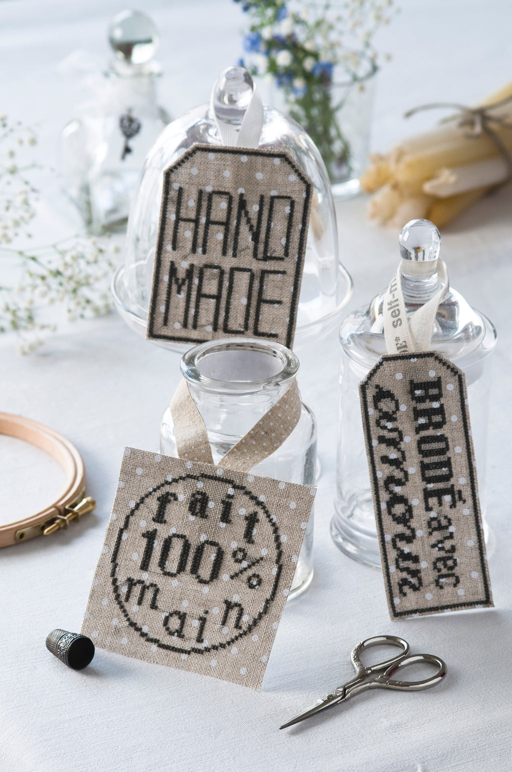 Mook point de croix : 15 créations mêlant petite couture et broderie, avec des motifs originaux autour de la mercerie — dés à coudre, boutons, rubans et ciseaux.
