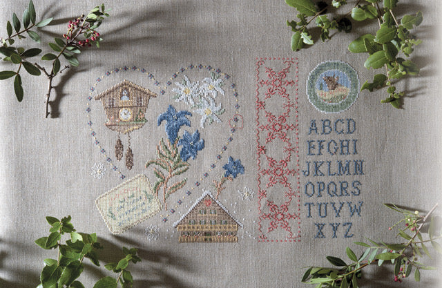Mook point de croix : 20 créations de Jennifer Lantini autour de l’hiver — nature, maison et Noël — coussins, tableaux et hottes à broder avec douceur.